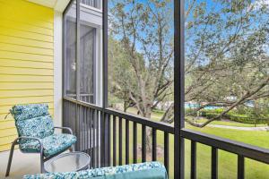 a chair sitting on a porch with a window at Exclusive 3BR villa: pools near Disney magic in Kissimmee