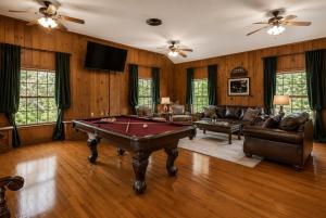a living room with a pool table in it at Historic Mansion-King Suite-The Blue Jay in Fort Smith