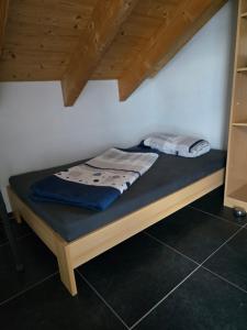 a bed in a room with a wooden frame at Haus Motorsport in Bad Saulgau