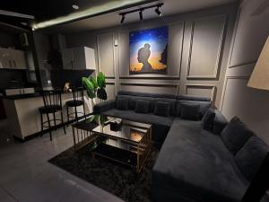 a living room with a couch and a table at 1 Bed Modern Apartment, Pool, Gym, Cinema in Lahore