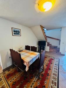 a dining room with a table and chairs at Apartments & rooms Velebit in Lovinac
