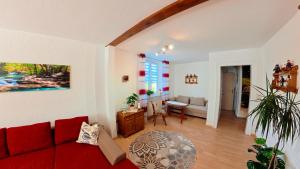 a living room with a red couch and a table at Ferienwohnung Glück auf in Gornsdorf