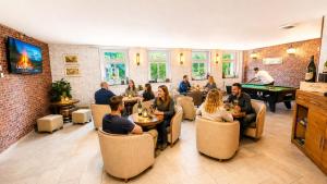 a group of people sitting at tables in a restaurant at Landhotel Peters - zwischen zwei Seen in Canow