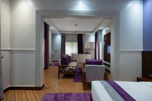 a hotel room with a bed and a dining room at Pieme hotel residence 