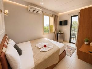 a bedroom with a bed with a flower on it at Garden Hotel Nile House in Cairo +19 photos