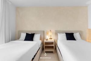 two beds sitting next to each other in a room at Pininfarina Studio Intracoastal View in Hallandale Beach