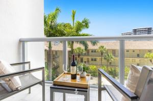 a bottle of wine on a table on a balcony at Pininfarina Studio Intracoastal View in Hallandale Beach +52 photos