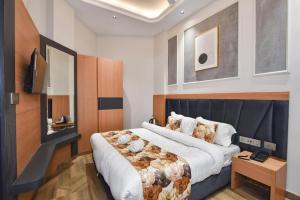 a bedroom with a large bed and a television at HOTEL La VILLA in Amritsar