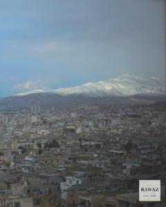 a view of a city with mountains in the background at Rawaz Hotel in As Sulaymānīyah