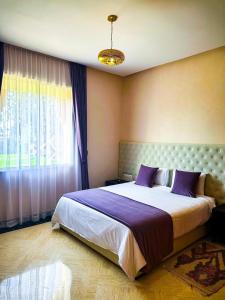 a bedroom with a large bed and a window at Villa zitoun in Aït Bou Zguia
