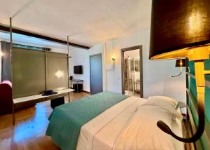 a bedroom with a large bed and a desk at SiRiuS rooms & charme in Villasimius