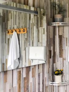 a bathroom with a mirror and a towel at Taylor the Burt in Penuwch