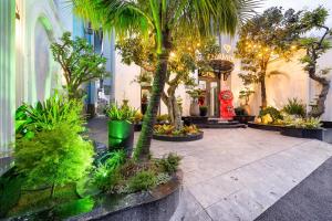 a courtyard with palm trees and plants in a building at Diamond Hotel in Bien Hoa
