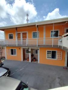 an orange building with a parking lot in front of it at SkyBlue Guesthouse by Concavus in Campos do Jordão