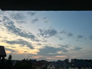 a cloudy sky over a city with houses at Apartamenty Leszczynowa in Łomża