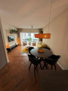 a living room with a table and chairs and a couch at Appartement Moustache in Goes