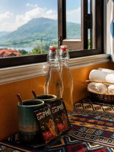 two bottles of soda sitting on a table near a window at Mộc An SaPa Home in Sapa