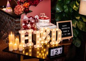 a table with lit candles and a birthday cake at Amsphere Homestay & Restaurant in Hanoi