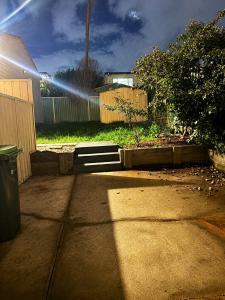 a beam of light shining on a backyard with a fence at 21A Armstrong Place in Schofields