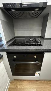 a kitchen with a stove top oven in a kitchen at Lux Apart in Khujand