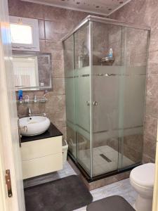a bathroom with a shower and a sink and a toilet at Chez moi in Bouzareah