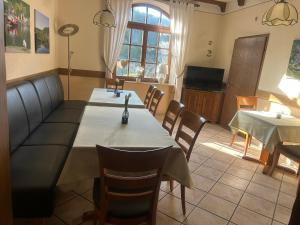 a dining room with two tables and a couch at Ferienhaus Knecht in Neef