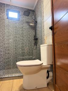 a bathroom with a toilet and a shower at Sea View Pedra Mar in Campanário +11 photos