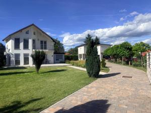 a white house with a brick driveway at Villa Amela in Ilidža