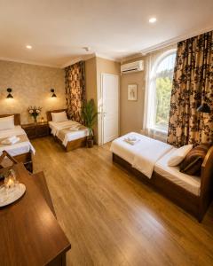a hotel room with two beds and a window at Hotel Kalanga in Tbilisi City +102 photos