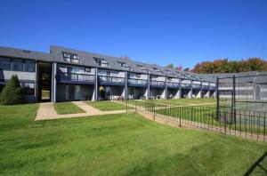 a large building with a grass field in front of it at Nautical Mile Resort in Wells