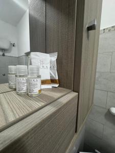 a cabinet with three jars of medicine in a bathroom at El Mar in Coldragone +17 photos