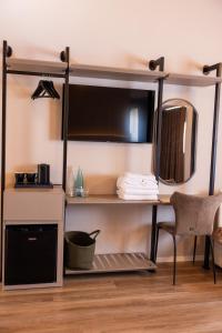 a room with a bunk bed with a desk and a mirror at KAÑ Inn in Vlorë