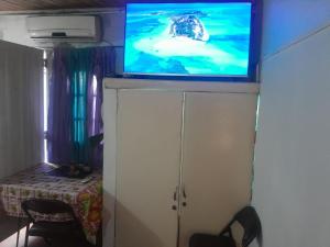 a television on top of a cabinet in a room at Aires del Atlántico Sur in Burzaco