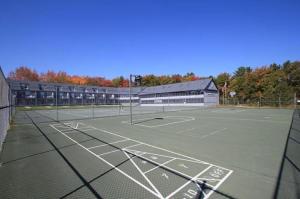 a tennis court with a net on it at Nautical Mile Resort in Wells