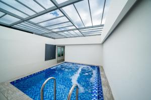 a swimming pool with a skylight in a house at Le House Boutique Hotel - 100m to the beach in Danang