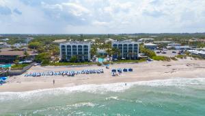 an aerial view of a beach with chairs and umbrellas at Costa d'Este Beach Resort & Spa in Vero Beach