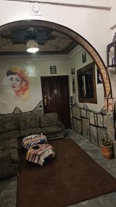a living room with a couch and a table at Dar chez bassou in Imilchil +1 photo