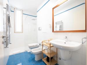 a bathroom with a sink and a toilet and a mirror at Dadu 150 in Bari +14 photos