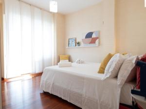 a bedroom with a white bed and a couch at Dadu 150 in Bari