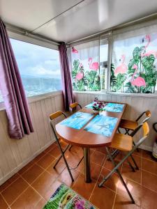 a dining room with a table and chairs and windows at Athena in Camporosso +18 photos
