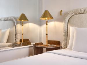 a hotel room with a bed and two lamps at ATHENA Pallas in Athens
