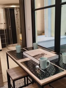 a table with two coffee cups on top of it at Bienvenue chez Coco in Dunkerque +40 photos