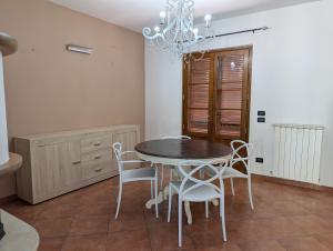 a dining room with a table and chairs at La Piccola Atene Oasi in Strettoia