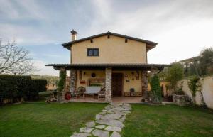 a large house with a stone pathway in front of it at Villa Concipat Rooms in Fonte Nuova