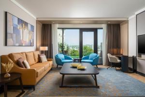 a living room with a couch and a table at Radisson Blu Leogrand Hotel in Chişinău