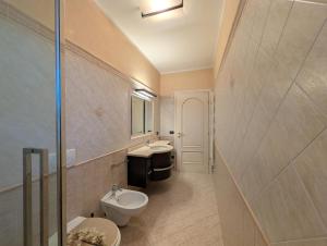 a bathroom with a toilet and a sink at La Piccola Atene Oasi in Strettoia