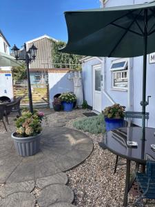 a patio with a table and an umbrella at Admiral Blake Guesthouse in Bridgwater