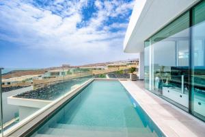 a swimming pool in the middle of a house at Villa Veiga with heated pool in Callao Salvaje
