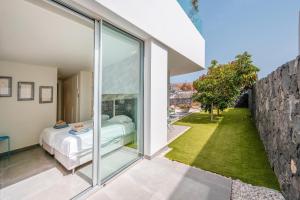 a bedroom with a bed and a large window at Villa Veiga with heated pool in Callao Salvaje +63 photos