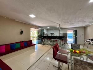 a living room with a couch and a table at Chacará Village do Rio Ouro in Conde